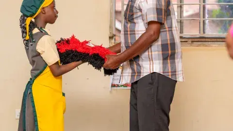 Hon.Amanya Mushega admiring door mat