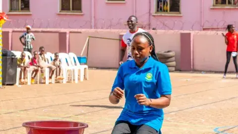 Parents vs teachers game - cup lifting with a balloon