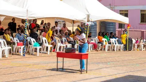 Parents vs teachers game - cup lifting with a balloon