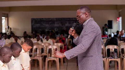 Parent praying for candidates